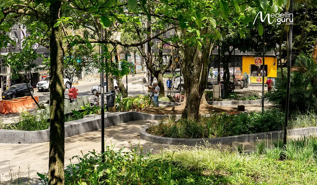 Green urban space of Parque Lleras in Medellín's El Poblado, surrounded by vibrant nightlife and entertainment venues