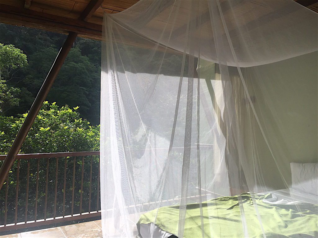 La Natura room in El Refugio, bed draped in a mosquito net