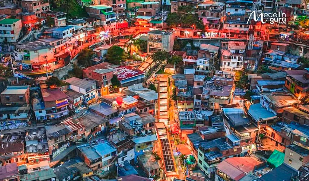 Panoramic view of Comuna 13, highlighting its famous graffiti murals and outdoor escalators in Medellín