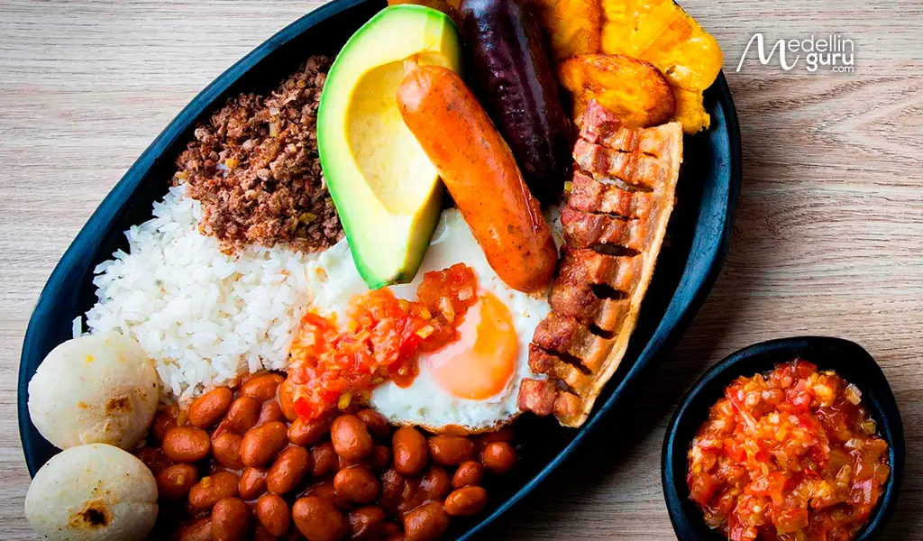 Traditional Bandeja Paisa plate from Medellín, Colombia, with rice, beans, ground meat, egg, and chicharrón