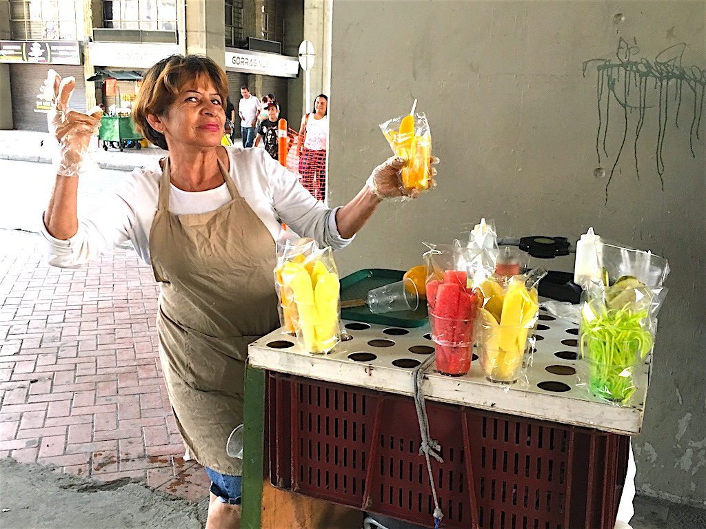 Plastic cups full of sliced tropical fruit can be purchased all over Medellin from street food carts. Maria at San Antonio stations arguably sells the best ripe mango in town