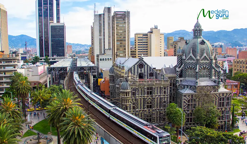 Medellín Metro train traveling through the city center, howcasing Medellín's efficient public transportation