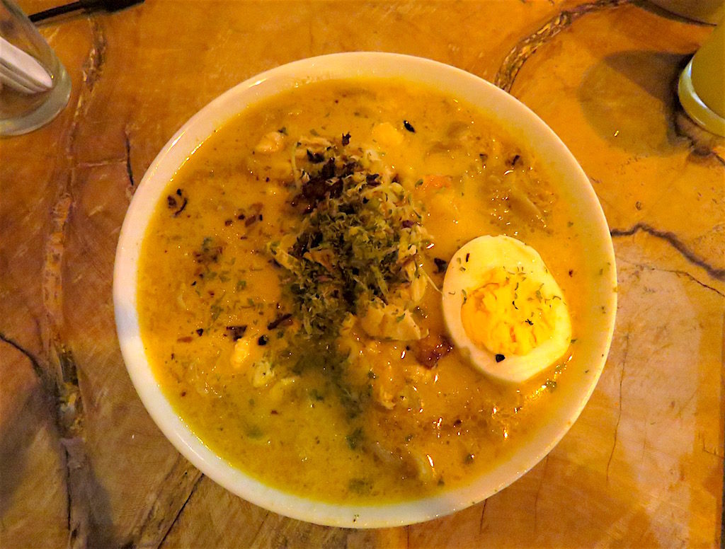 Laksa noodles soup, which is a freshly made noodle soup with spicy coconut broth served with prawns, chicken and egg