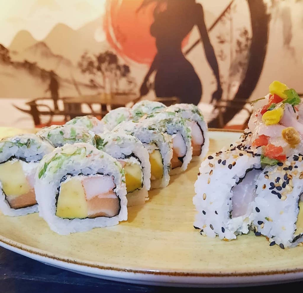 Monster Rolls filled with fresh salmon, avocado and cream cheese topping with wuakame cream cheese and masago, photo courtesy of Daisuki Sushi Wok