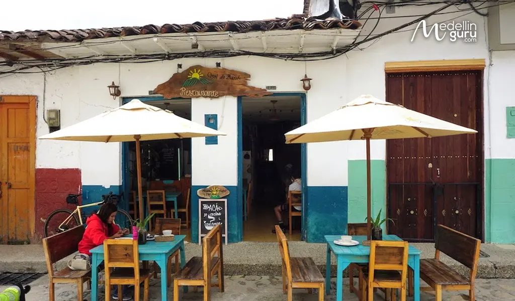 Digital Nomad working at a blue wooden table outside a colonial Concepción cafe sanctuary.