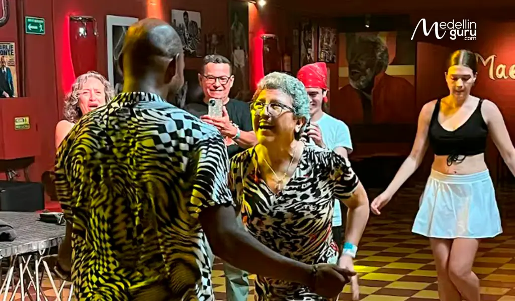 Salsa dancers performing performing in a vibrant Cali dance club