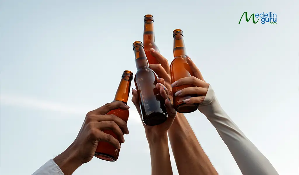 A cheerful group clinking beer bottles, symbolizing friendship and camaraderie in Medellín