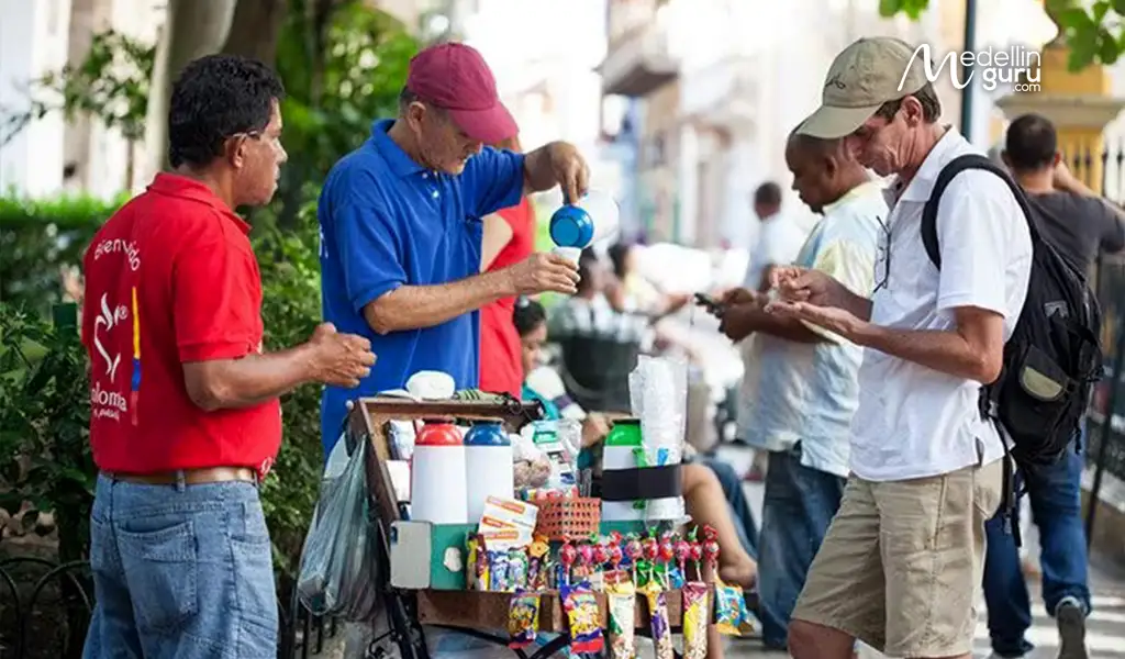 A colorful street cart in Colombia serving tinto, showcasing the vibrant coffee culture