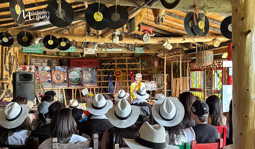 Don Guillermo welcoming a group of visitors to experience the Medellín Flower Festival at the silletera farm